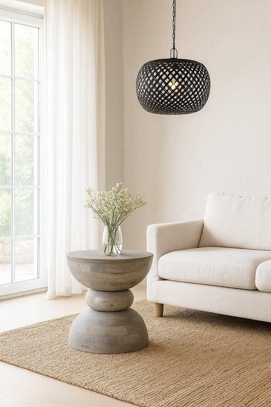 Living room with a white sofa, concrete side table, and black pendant light.