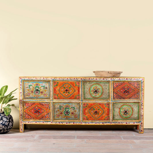 Decorative wooden cabinet with colorful patterns on a wooden floor.