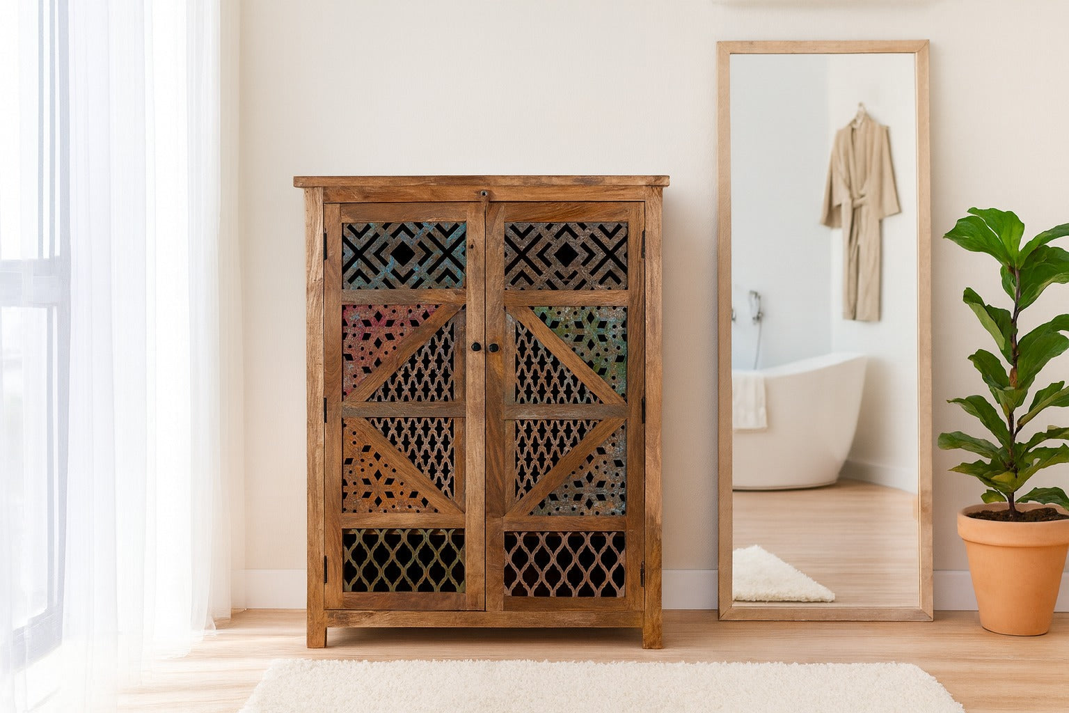 Wooden cabinet with decorative lattice doors in a room with a mirror and plant.