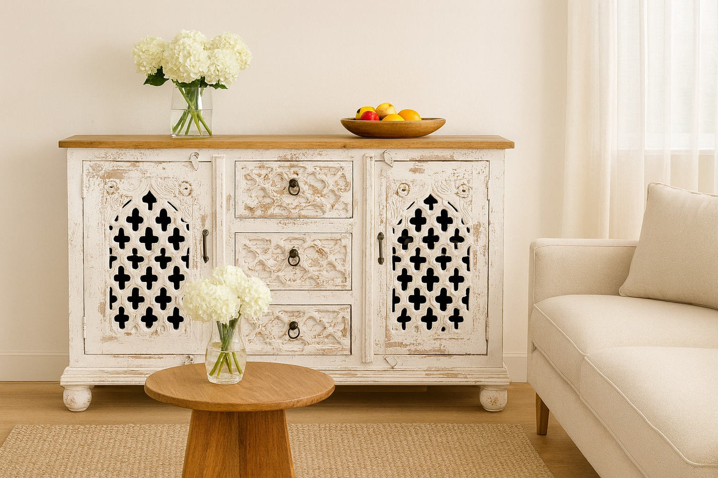 Decorative sideboard with floral arrangements in a living room setting