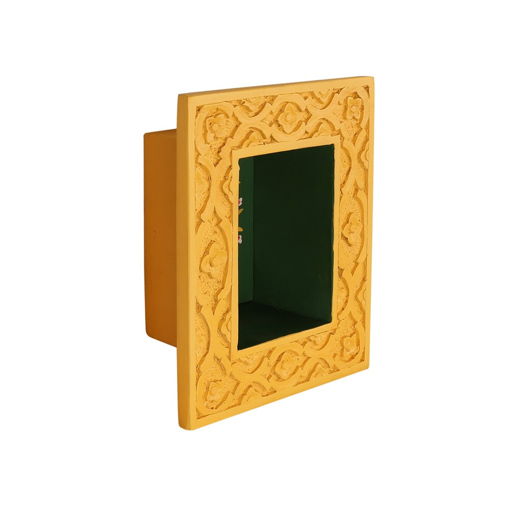"Elegant brass idol wall shelf featuring a polished brass finish and intricate carvings, designed for wall decor or showcasing religious idols. This antique-inspired piece adds a vintage touch to your living room, pooja room, or bedroom while doubling as a functional shelf for small decorative items