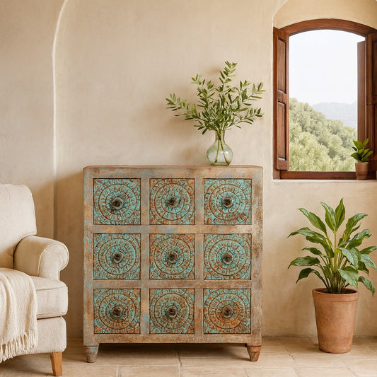 Decorative wooden cabinet with turquoise patterns in a room with a window and plants.