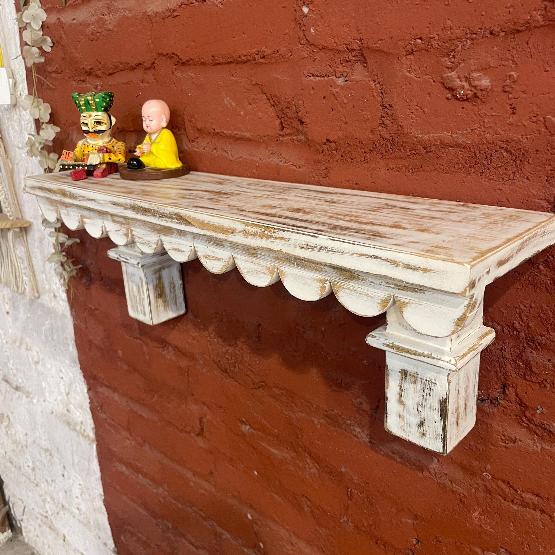 Carved whitewashed wall shelves with a vintage aesthetic, doubling as a wooden wall bookshelf. Perfect for those who love blending utility with style, this versatile piece adds charm to kitchens, bathrooms, or living rooms while holding books, vases, or small decor items.