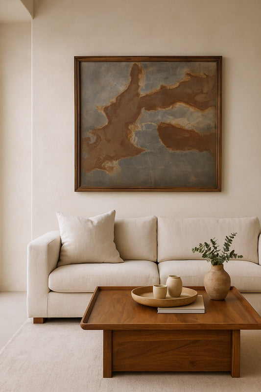 Beige sofa with a wooden coffee table and decorative items in a living room setting.
