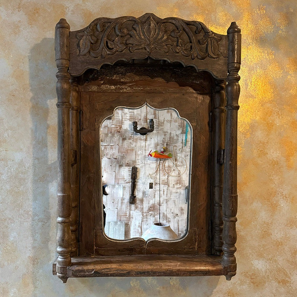 Antique carved mirror frame with detailed craftsmanship, perfect for vintage interior design