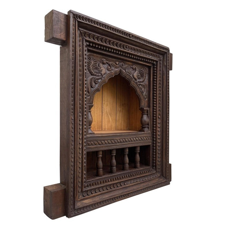 Traditional mandir wall decor with a wall-mounted wooden shelf, designed to hold brass idols, pooja essentials, and vintage temple decor. Its antique white finish and carved details make it a versatile choice for enhancing spiritual corners, bedrooms, or entryways.