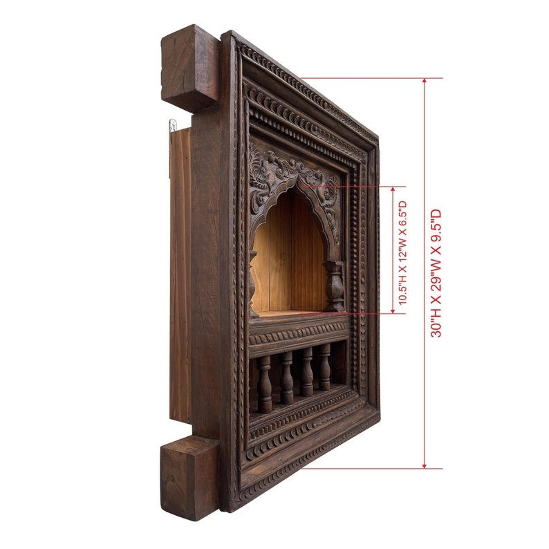 Handcrafted mandir wall shelf featuring ornate woodwork and a brass accent. This multi-purpose wooden wall bookshelf doubles as a pooja stand, perfect for arranging sacred idols, incense holders, or wall-mounted temple decor. A timeless addition to any living room or prayer area
